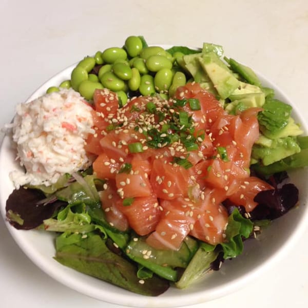 Toro Sushi Poke House's poke bowl with salmon, crab salad, edamame, avocado, and greens.