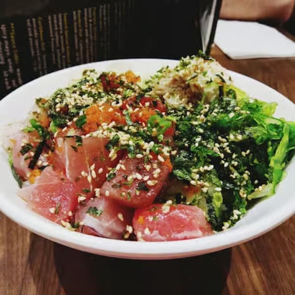 Toro Sushi Poke House's poke bowl with tuna, roe, seaweed, and sesame seeds.